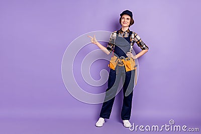 Full length body size photo curious woman engineer wearing cap overall pointing looking empty space pastel Stock Photo