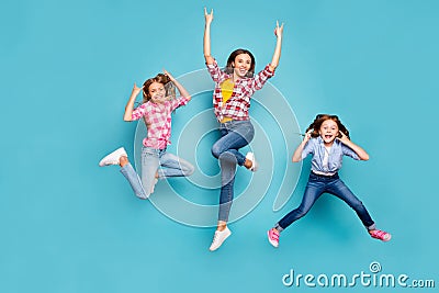 Full length body size photo of funky funny excited trendy family who are rock fans jumping joyfully wearing jeans denim Stock Photo