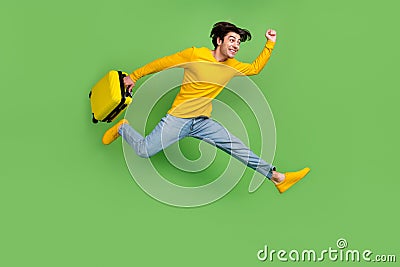 Full length body size photo man keeping heavy bags running to airport late isolated pastel green color background Stock Photo