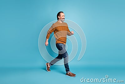 Full length body size photo middle-aged bearded man smiling stepping hurrying in stylish clothes isolated on bright blue Stock Photo