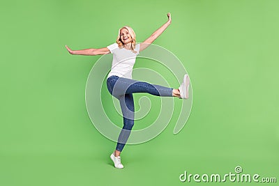 Full length body size photo overjoyed elder woman in casual outfit smiling isolated pastel green color background Stock Photo