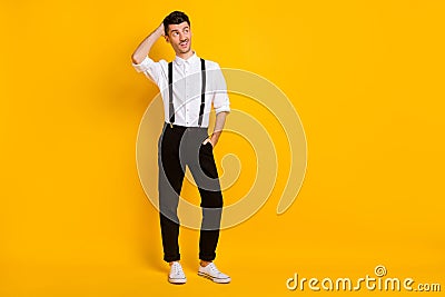 Full length body size photo unsure doubtful clueless man looking blank space touching head isolated on vivid yellow Stock Photo