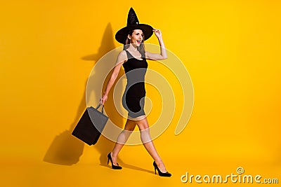 Full length body size profile side view of her she attractive pretty classy cheerful thin lady wizard carrying bags Stock Photo