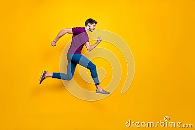 Full length body size side profile photo of fast quick handsome man wearing blue pants trousers footwear running jumping Stock Photo