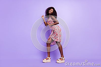 Full length body size side profile photo overjoyed curly girl dancing in dress at party isolated pastel purple color Stock Photo