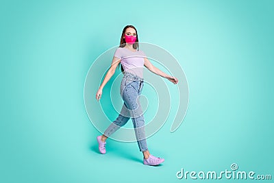 Full length body size side profile portrait of confident girl wearing protective face mask going isolated on vibrant Stock Photo