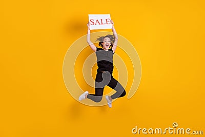 Full length body size view of attractive overjoyed cheerful girl jumping holding in hands placard isolated bright yellow Stock Photo