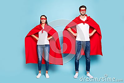 Full length body size view of his he her she nice attractive content serious couple wearing red superhero outfit hands Stock Photo