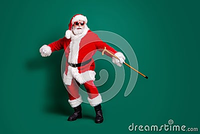 Full length body size view of his he nice attractive cheerful cheery Santa holding in hand cane having fun dancing Stock Photo