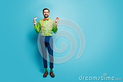 Full length body size view of his he nice attractive cheerful guy using digital device fast payment isolated over bright Stock Photo