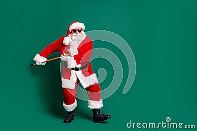 Full length body size view of his he nice attractive handsome cheery Santa holding in hand cane having fun dancing rest Stock Photo