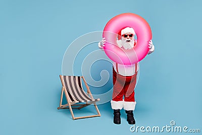 Full length body size view of his he nice cool comic glad cheerful cheery fat Santa carrying pink swimming circle having Stock Photo