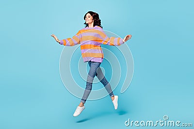 Full length body size view of pretty dreamy carefree fit cheerful wavy-haired girl jumping going over bright Stock Photo