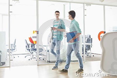 Full-length of businessmen walking at creative work space Stock Photo