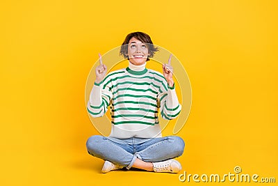 Full length cadre of bet advertiser girl directing fingers empty space look interested lottery cosmolot isolated on Stock Photo