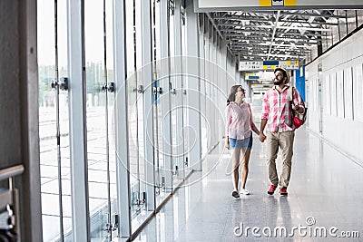 Full-length of couple walking in covered passage Stock Photo