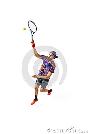 Full-length dynamic image of young man, tennis player in bright sportswear in motioned during game, hitting ball Stock Photo