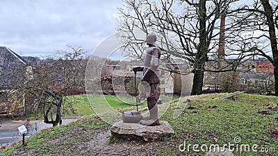 Full-length metal knight near the ruins of an old castle in the Latvian village of Aizpute in January 2023 Editorial Stock Photo