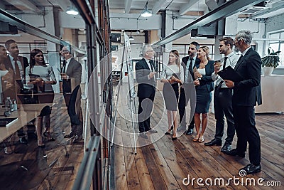 Full length of modern businessman conducting Stock Photo