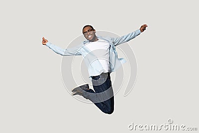 Full length overjoyed millennial african american man jumping. Stock Photo