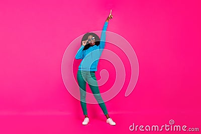 Full length photo of afro american young woman look point finger empty space dancer isolated on pink color background Stock Photo