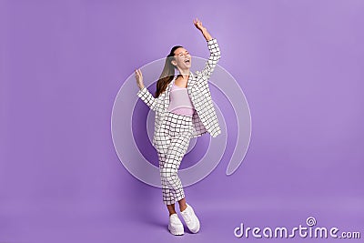 Full length photo of attractive funky young woman raise hands good mood dance isolated on purple color background Stock Photo