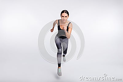 Full length photo of brunette ponytail haired woman jump run endurance sport on grey color background Stock Photo