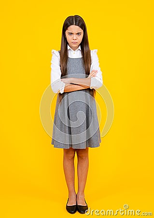 Full length photo of brunette teen girl wear casual clothes isolated on yellow background. Angry teenager girl, upset Stock Photo