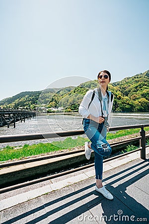 Elegant traveler relaxing next to the river Stock Photo