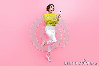 Full length photo of excited funky lady wear knitter pullover chatting instagram twitter telegram facebook isolated pink Stock Photo