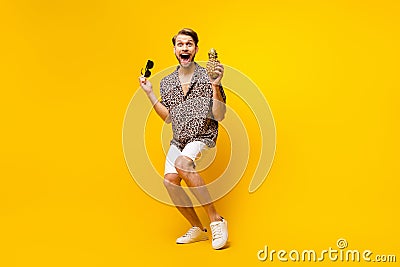 Full length photo of excited funny gentleman dressed print shirt arm dark glasses pineapple dancing isolated yellow Stock Photo