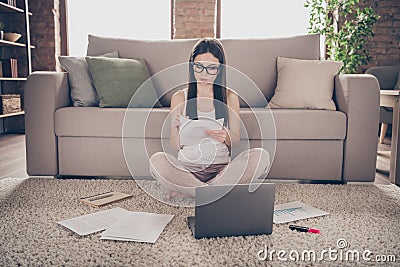 Full length photo of focused smart girl sit carpet legs crossed hold document paper write check collars startup Stock Photo