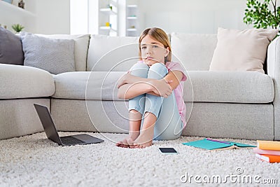 Full length photo of frustrated girl sit floor carpet miss friends study remote corona virus quarantine in house indoors Stock Photo