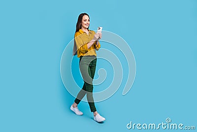 Full length photo of funky excited lady wear yellow shirt texting instagram twitter telegram facebook empty space Stock Photo