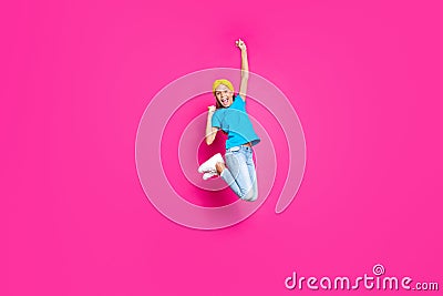 Full length photo of funny crazy child jump delighted celebrate lucky sporty competition victory raise fists scream yeah Stock Photo