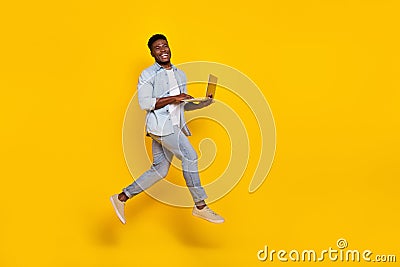 Full length photo of guy jump high use netbook search browse web discounts isolated shine color background Stock Photo