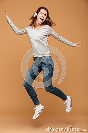 Full length photo of joyful pretty girl in casual wear jumping w Stock Photo