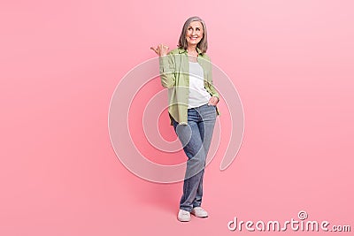 Full length photo of lovely satisfied lady wear stylish clothes presenting empty space store mall center on Stock Photo