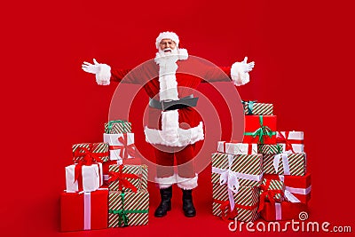 Full length photo of positive good mood pensioner santa claus demonstrating pile stack new year gifts isolated on red Stock Photo