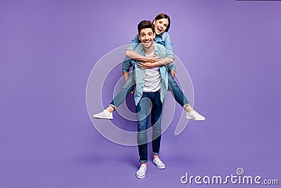 Full length photo of romantic funny funky married people have fun date hug piggyback enjoy date wear stylish trendy Stock Photo