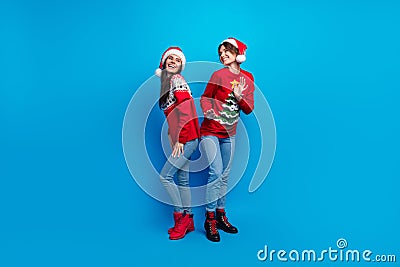 Full length photo of shiny cute women santa elves wear ornament pullovers dancing x-mas event isolated blue color Stock Photo