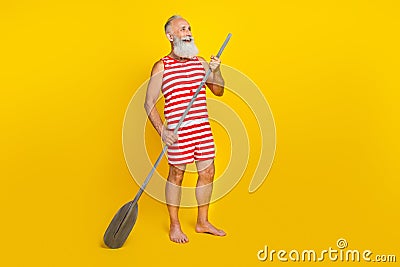 Full length photo of sportive retired man in swimsuit sup boat surfing oar on river look empty space isolated over Stock Photo