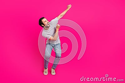 Full length photo of young cheerful guy look empty space celebrate win lucky isolated over magenta color background Stock Photo
