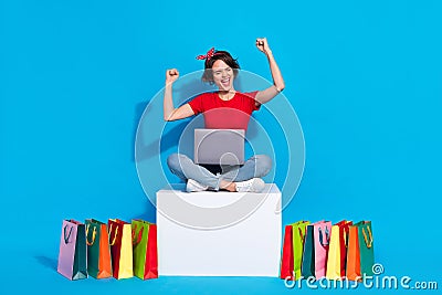 Full length photo of young excited girl celebrate lucky discount lottery fists hands shop laptop isolated over blue Stock Photo