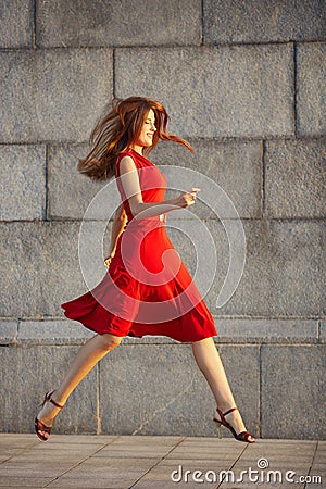 Full length portrait of attractive elegant young woman in red dress Stock Photo