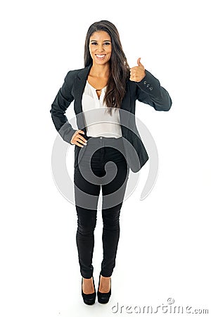 Full length portrait of a beautiful latin businesswoman smiling and making thumbs up sign standing isolated on a white background Stock Photo