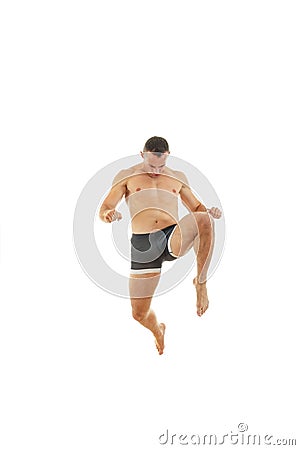 Full length portrait of boxer fighter in kick motion Stock Photo