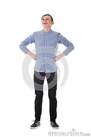 Full length portrait brave teen boy posing hands on hips showing power like a superhero laughing in front of his fears isolated Stock Photo