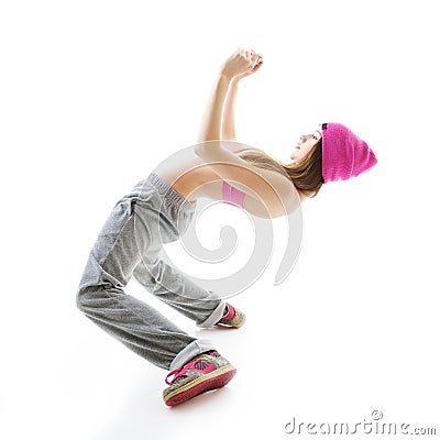 Full-length portrait of carefree girl in gray pants, pink top and hat jumping and dancing. Teen girl hip-hop dancer, over white Stock Photo