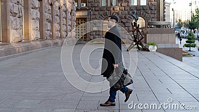 Full length portrait of a confident young businessman walking in the city with a bag Stock Photo